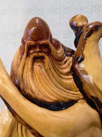 太行崖柏寿星公摆件乔迁、祝寿，太行崖柏三色崖柏寿星公，俏色巧雕原皮原色，雕刻细致入微，馈赠最佳伴手礼！尺寸：高；33长32宽22胡须衣襟处有轻微裂痕，无裂不崖柏，木制家具也会有裂痕属于正常现象，不影响摆放。介意者勿扰！