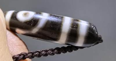 清末民国二眼天珠项链清末民国二眼天珠
此款二眼天珠是小年份大清至民国。可见明显的岁月包浆痕迹，珠体有明显的油沁，这是由于长时间佩戴，人体的油脂已经渗透到玛瑙里，产生了灰沁。
​尺寸:3.8*1.1cm
​