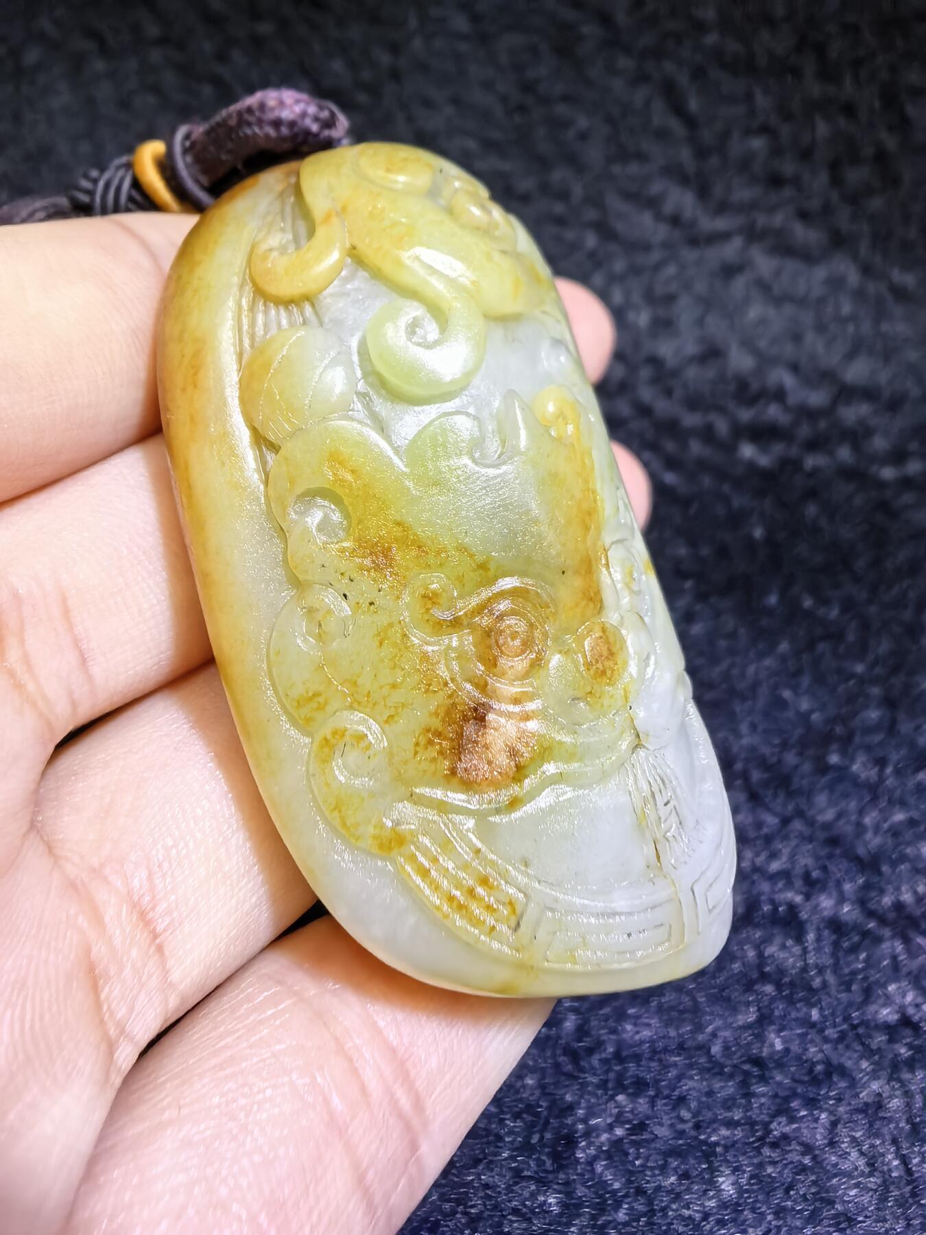 收藏级新疆喀什河籽料，府上有龙手把件男款，原籽洒金皮，可见天然毛孔撞击坑等。原皮原色，俏色巧雕寓意吉祥安康，尺寸：5.8cm*3.9cm**2.1cm
克重：75.2g自带国检证书！