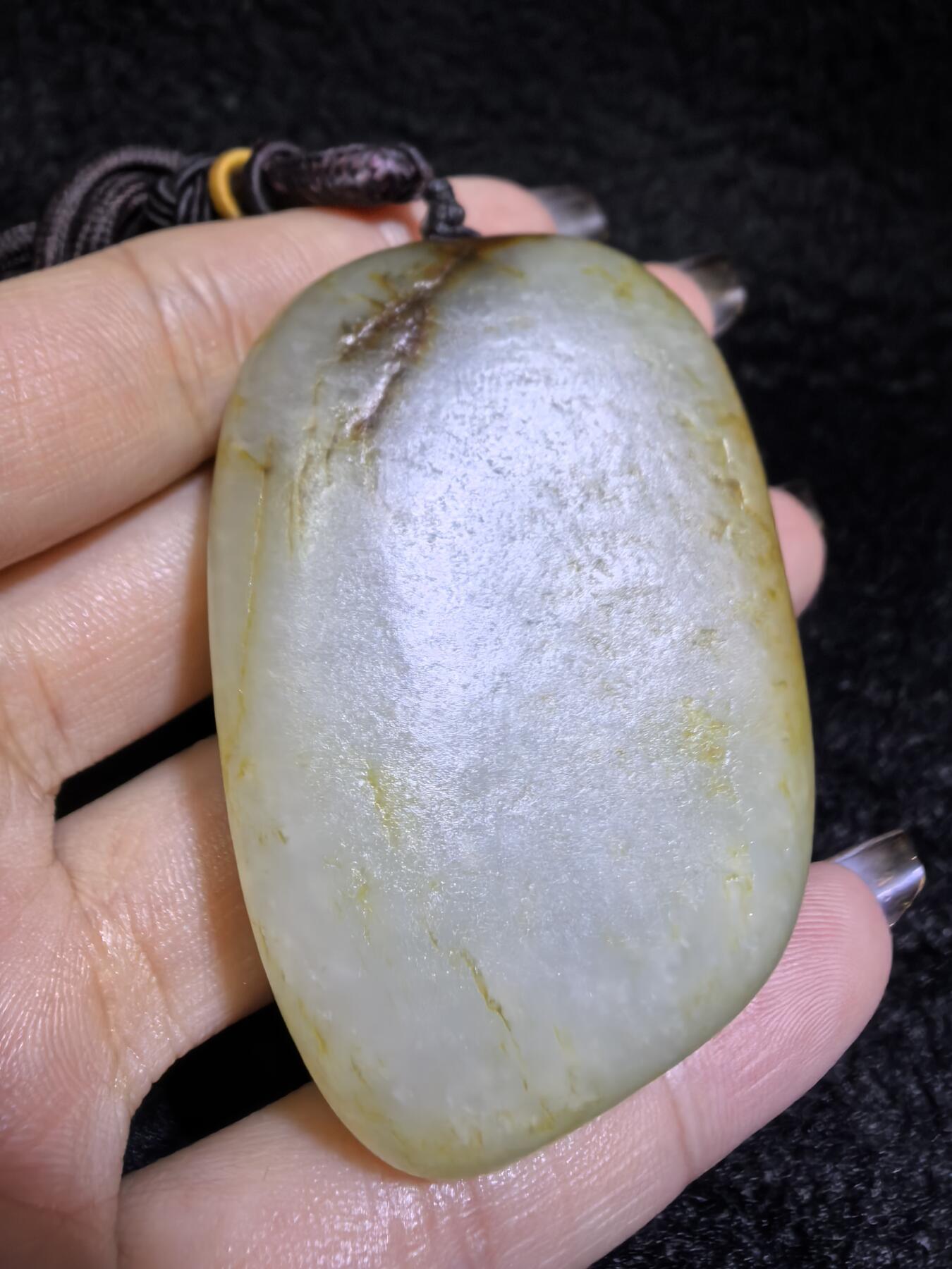 收藏级新疆喀什河籽料，府上有龙手把件男款，原籽洒金皮，可见天然毛孔撞击坑等。原皮原色，俏色巧雕寓意吉祥安康，尺寸：5.8cm*3.9cm**2.1cm
克重：75.2g自带国检证书！