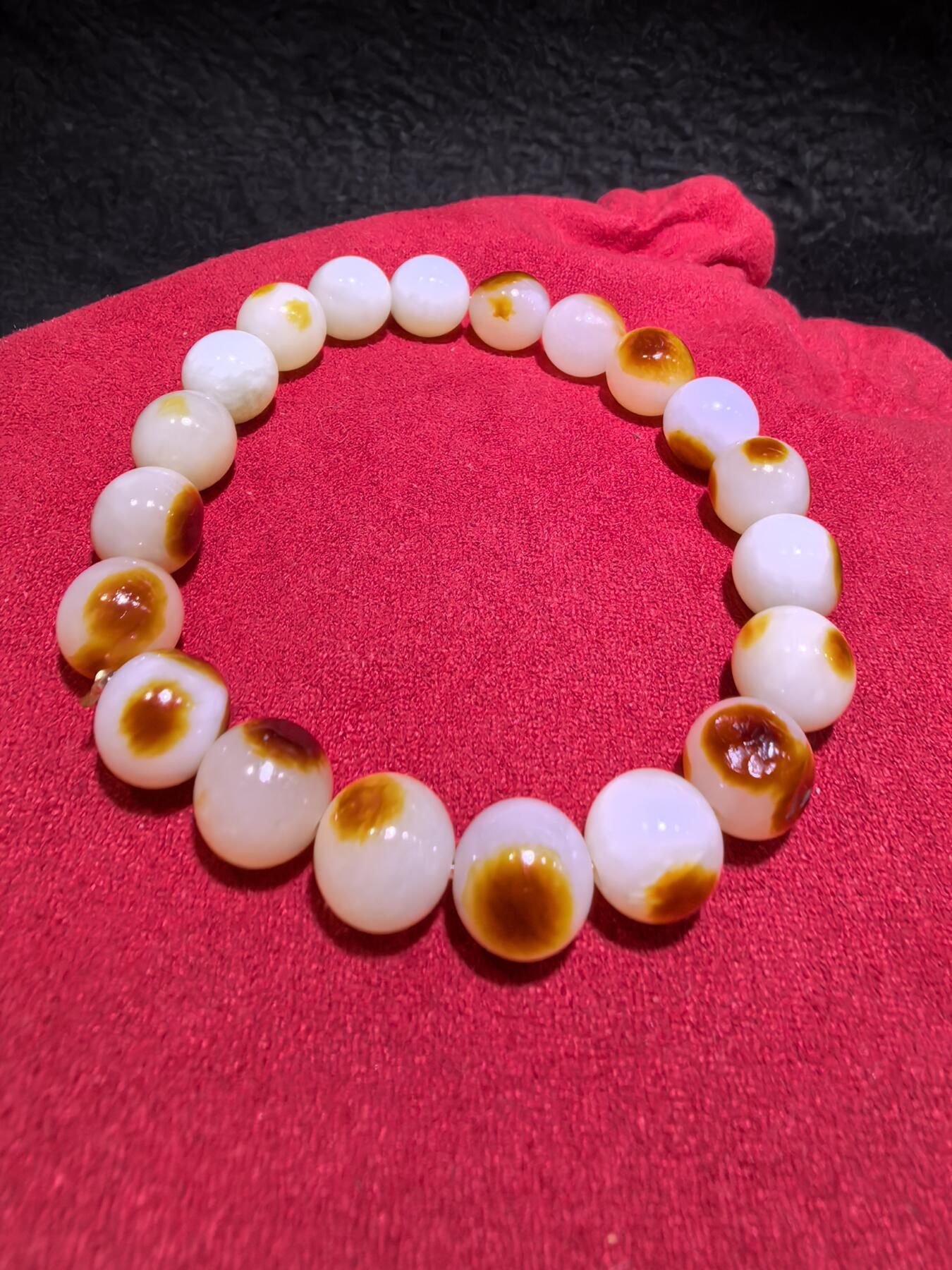 收藏级新疆和田籽料玛丽艳枣红皮手串佛珠男女款，原皮原色，高油高细，玛丽艳红皮的和田籽料，其皮色特点鲜明，常令人惊艳。这种被誉为老河道料的美玉，其色泽鲜艳饱满，宛如晚霞中的一抹红云，引人驻足欣赏。同时，其皮色与玉质紧密结合，相互映衬，更显独特魅力。个别珠微结构，不归圆，尺寸:1.0cm男女均可佩戴。克重:30g