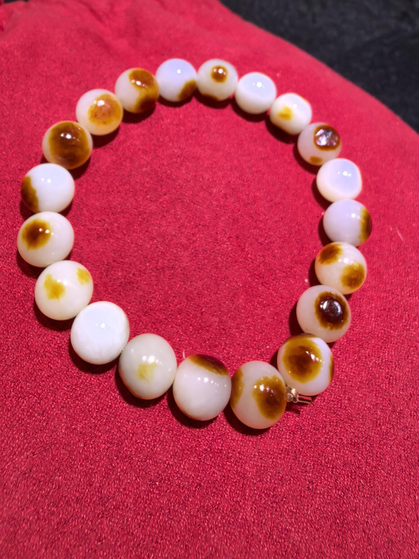 收藏级新疆和田籽料玛丽艳枣红皮手串佛珠男女款，原皮原色，高油高细，玛丽艳红皮的和田籽料，其皮色特点鲜明，常令人惊艳。这种被誉为老河道料的美玉，其色泽鲜艳饱满，宛如晚霞中的一抹红云，引人驻足欣赏。同时，其皮色与玉质紧密结合，相互映衬，更显独特魅力。个别珠微结构，不归圆，尺寸:1.0cm男女均可佩戴。克重:30g