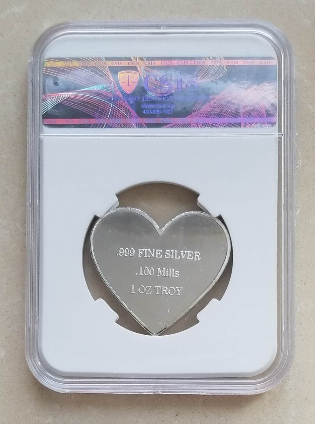 【币观天下】第八十六期钱币拍卖 美国制造大熊猫1盎司心形彩色银章，信泰评级封装。