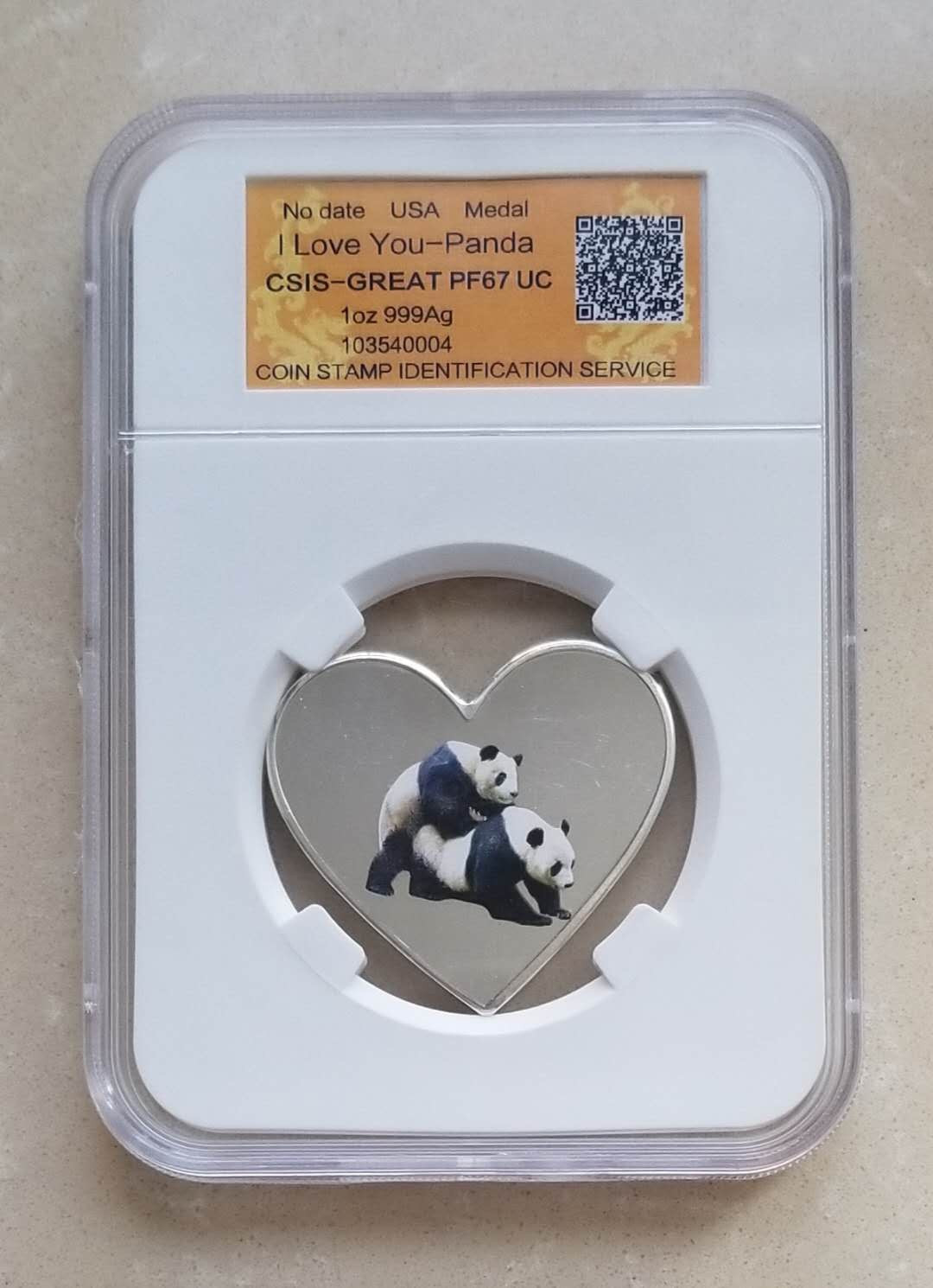 【币观天下】第八十六期钱币拍卖 美国制造大熊猫1盎司心形彩色银章，信泰评级封装。