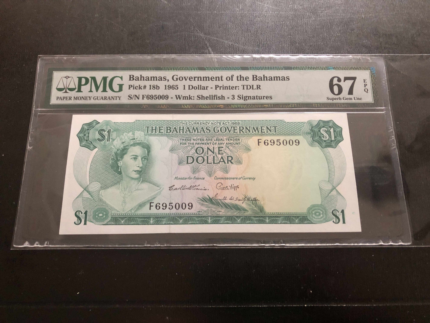 【收藏联盟】第134期拍卖——昆士顿高地战役（共50拍） 巴哈马 1965年首发年份 1元  PMG67EPQ  经典彩背 女王无47号码
