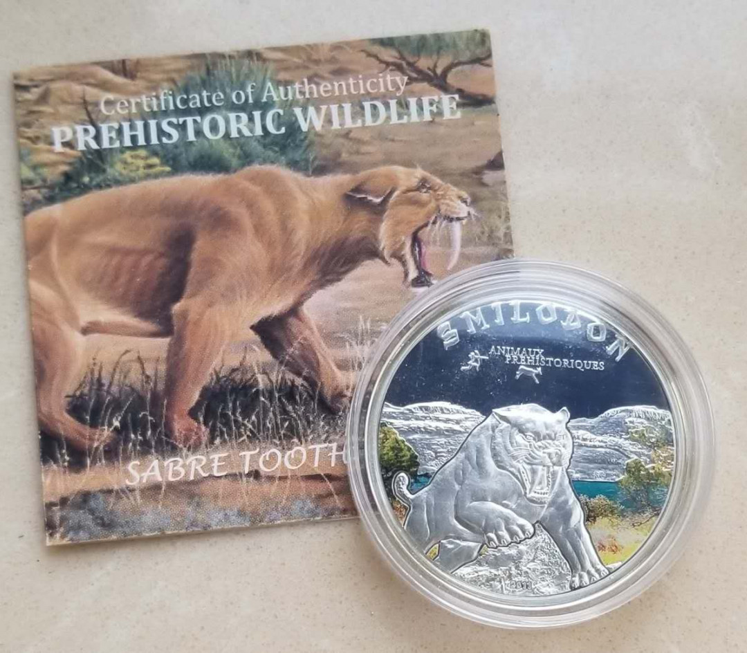 【币观天下】第109期钱币拍卖 科特迪瓦2011年剑齿虎彩色银币