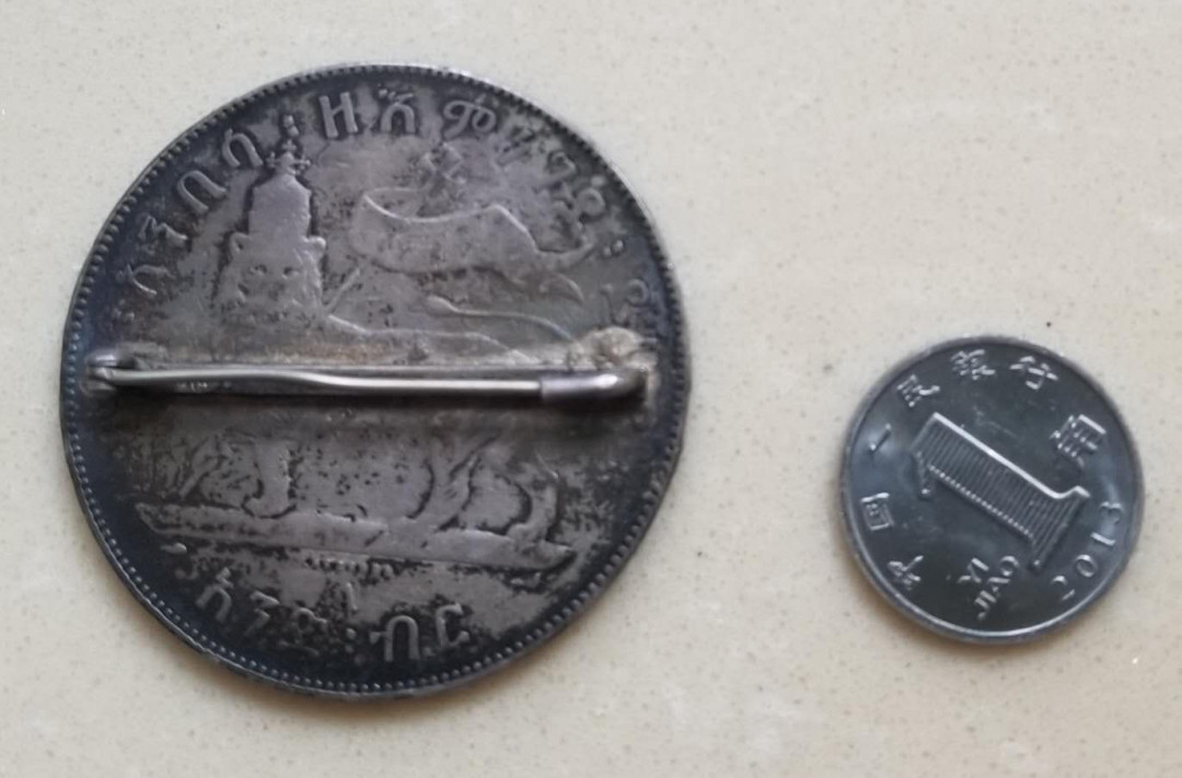 【币观天下】第134场拍卖【元旦场】 埃塞俄比亚帝国1比尔老银币胸针挂件  重30克品如图，胸针式饰品，非洲的古旧钱币加工制品少见
