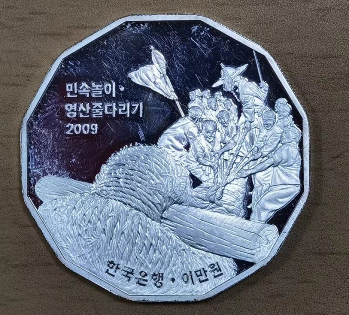 北京马甸外币专卖微拍第六十期，外国金银币专场，陆续上新，欢迎光临 韩国 2009年 20000元 传统民间游戏龙山拔河 19克纪念银币，成色900，有划痕品相如图，