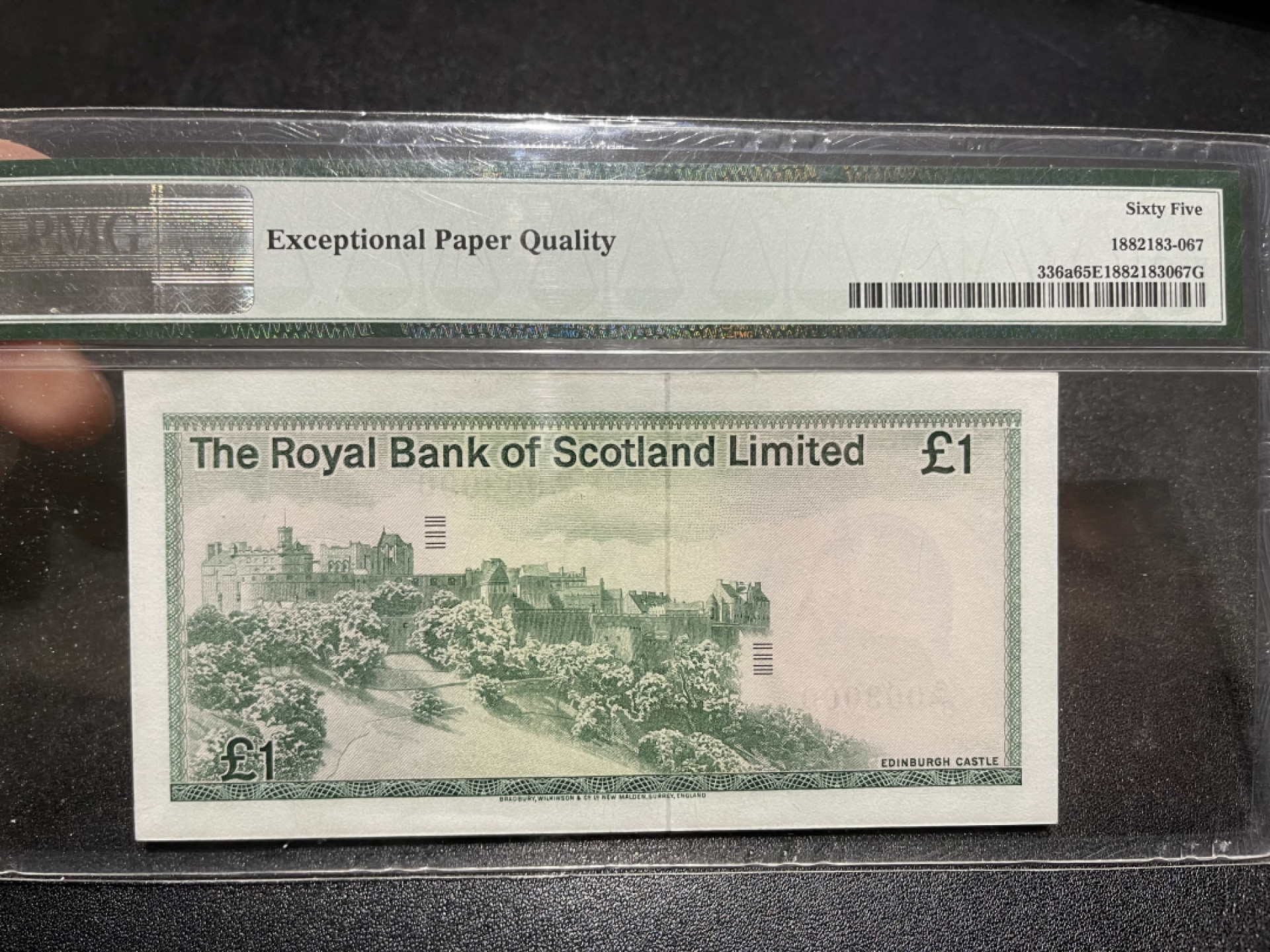 《外钞收藏家》第一百三十八期拍卖（本期91件） 1975年苏格兰 1镑  PMG65 003000 靓号 豹子号 BWC作品