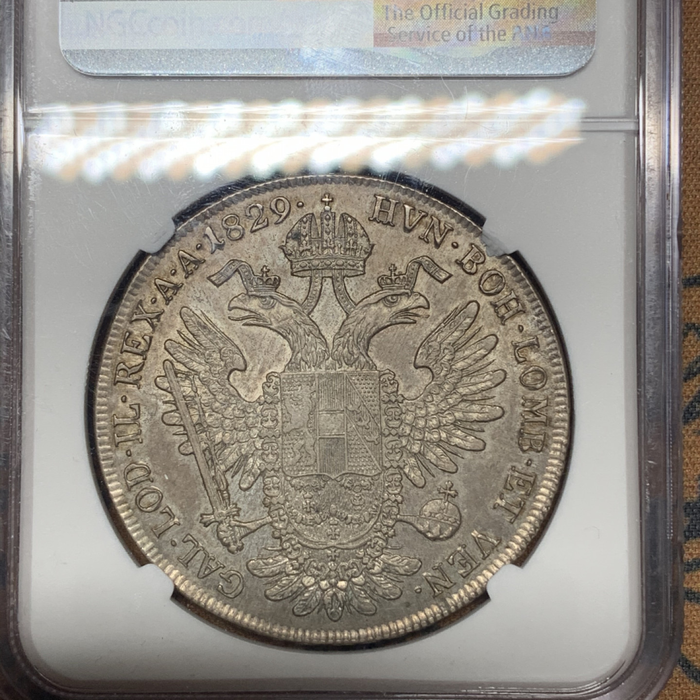 《竞宝斋》钱币微拍-第13场-本周日，周一2场连拍（全场顺丰包邮） 第三名 NGC-AU55 奥地利 1829年 佛朗茨一世 1泰勒 银币 漂亮的欧洲包浆