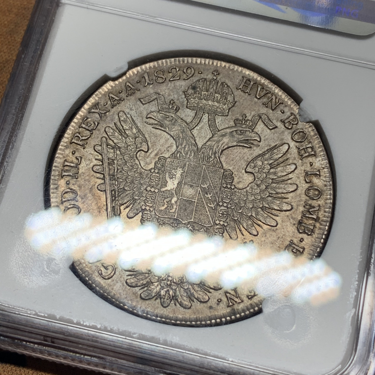 《竞宝斋》钱币微拍-第13场-本周日，周一2场连拍（全场顺丰包邮） 第三名 NGC-AU55 奥地利 1829年 佛朗茨一世 1泰勒 银币 漂亮的欧洲包浆