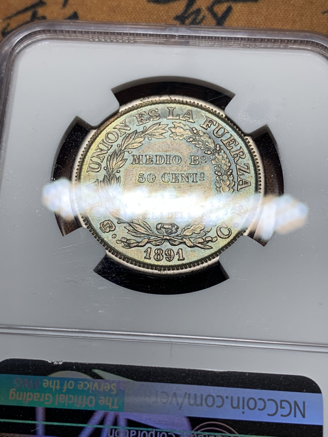 《竞宝斋》钱币微拍-第14场-本周日，周一2场连拍（全场顺丰包邮） NGC-AU 玻利维亚 1891年 无重版 50分 银币 带点蓝彩 很漂亮