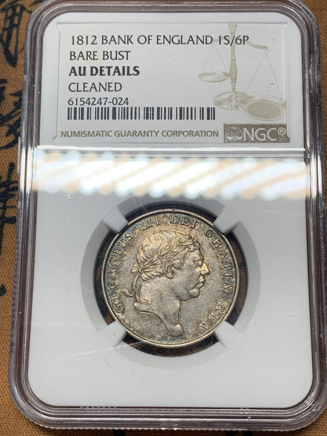《竞宝斋》钱币微拍-第17场-本周日，周一2场连拍（全场顺丰包邮） NGC-AU 英国 英格兰 1812年 乔三 1先令6便士 银币 酱彩包浆 细节状态都很好 少见