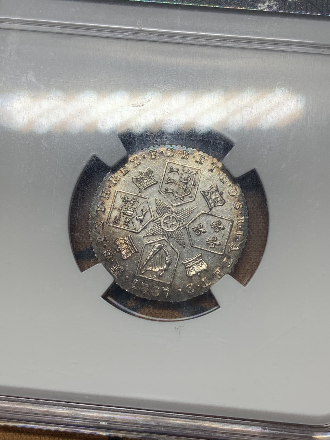 《竞宝斋》钱币微拍-第17场-本周日，周一2场连拍（全场顺丰包邮） NGC-AU58 英国 1787年 乔三 6便士 银币 环彩 细节清晰一流的状态