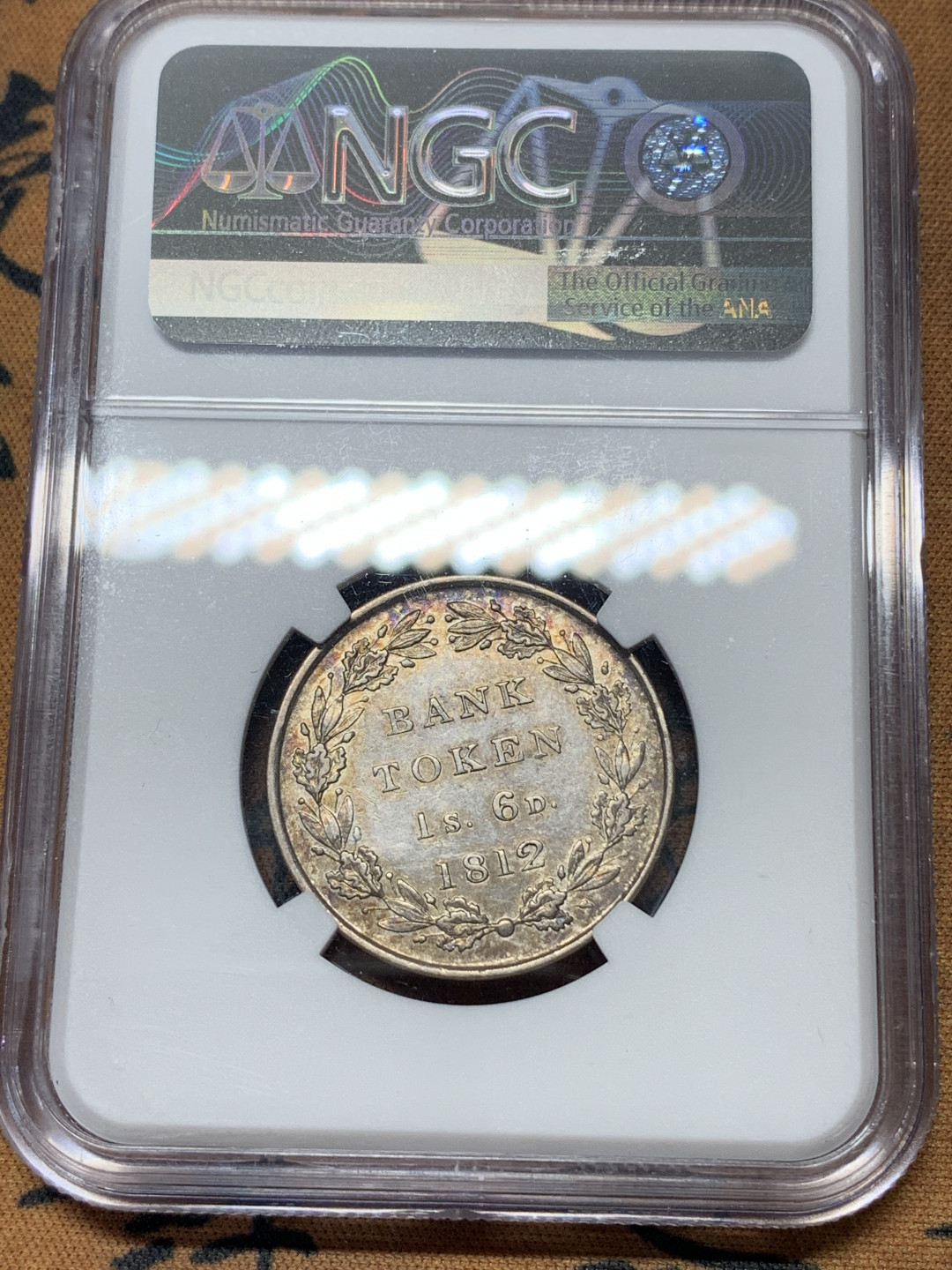 《竞宝斋》钱币微拍-第17场-本周日，周一2场连拍（全场顺丰包邮） NGC-AU 英国 英格兰 1812年 乔三 1先令6便士 银币 酱彩包浆 细节状态都很好 少见