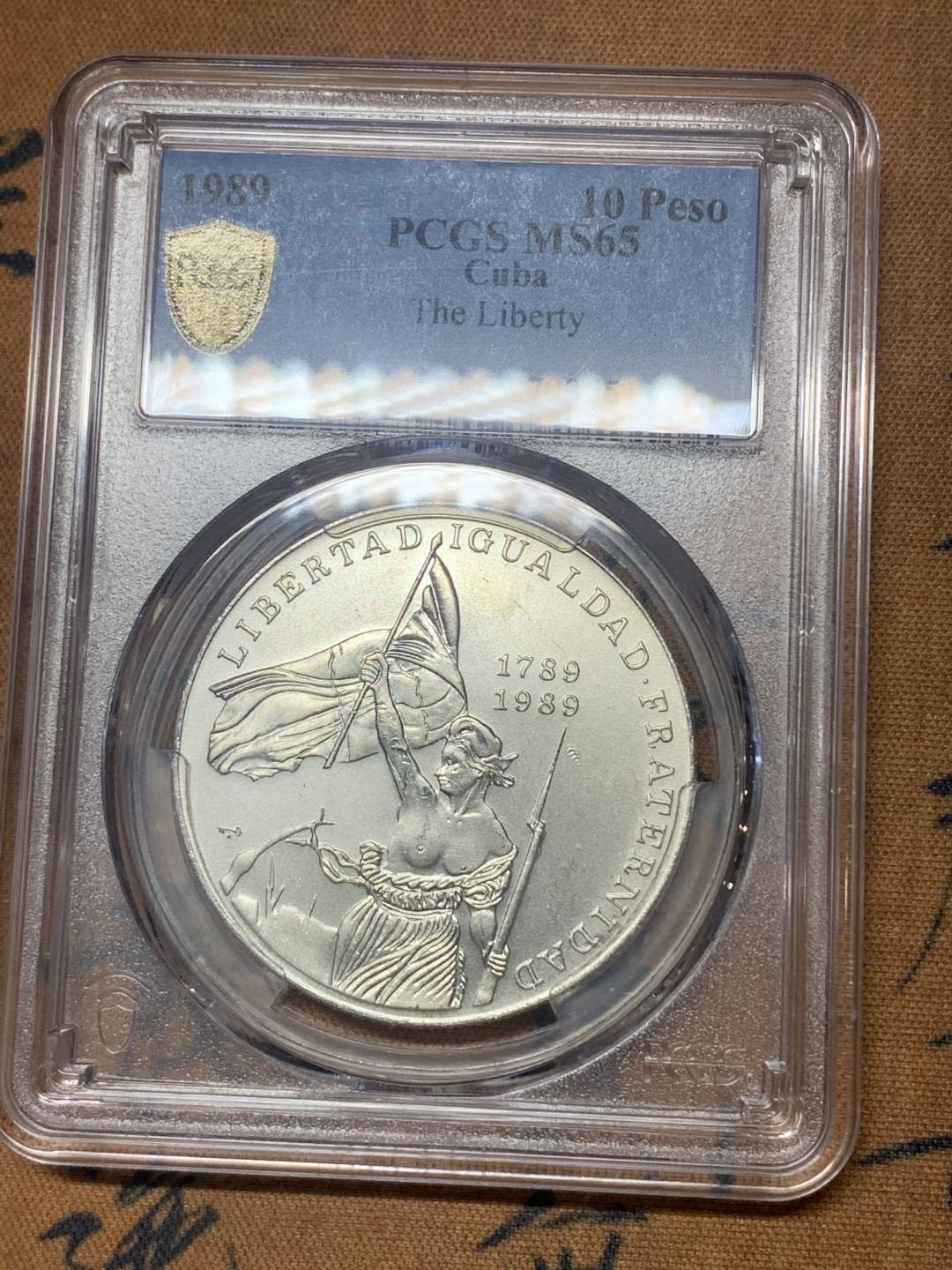 《竞宝斋》钱币微拍-第18场-本周日，周一2场连拍（全场顺丰包邮） PCGS MS65 古巴1989年圣女贞德10比索银币