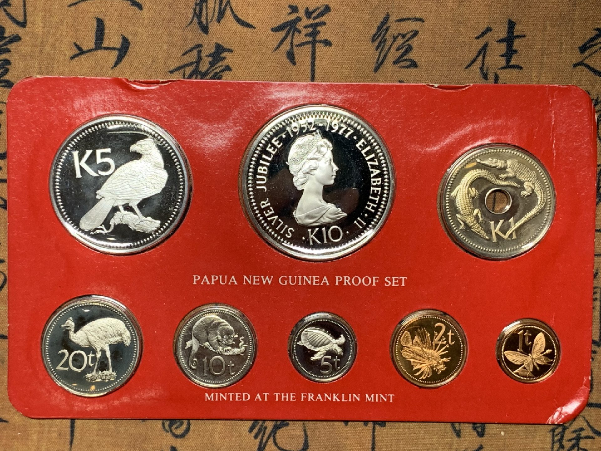 《竞宝斋》钱币微拍-第25场-本周日，周一2场连拍（全场顺丰包邮） 巴布亚新几内亚 1977年纪念英女皇执政25周年原装精制套币（附证书） 含2枚大银币 一枚铸有年轻女皇肖像