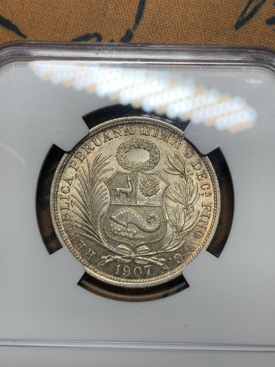 《竞宝斋》钱币微拍-第25场-本周日，周一2场连拍（全场顺丰包邮） ngc-ms65 1907年秘鲁半索尔坐洋女神 包浆好 状态佳 少见稀有特年 sbp落槌价240刀 盒子左下角有磕