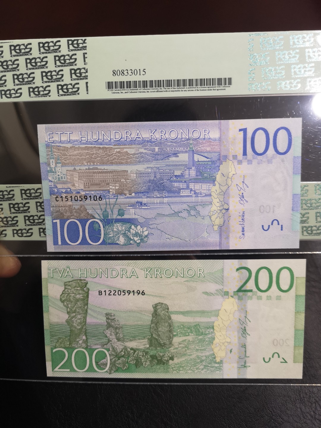 《外钞收藏家》第一百六十五期拍卖（本期80件） 瑞典最新版100、200克朗 两张一起 PCGS绿标