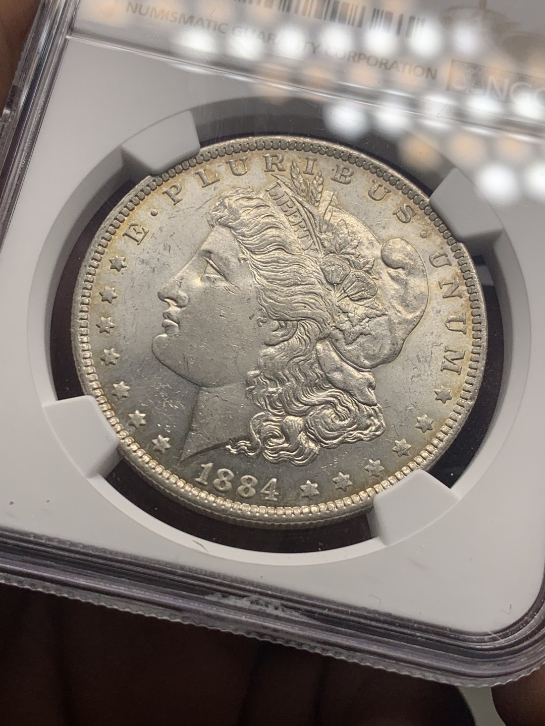 《竞宝斋》微拍-第32场-周日（全场顺丰包邮） NGC-MS62 美国 1884年 1元 摩根银币 双面淡彩包浆