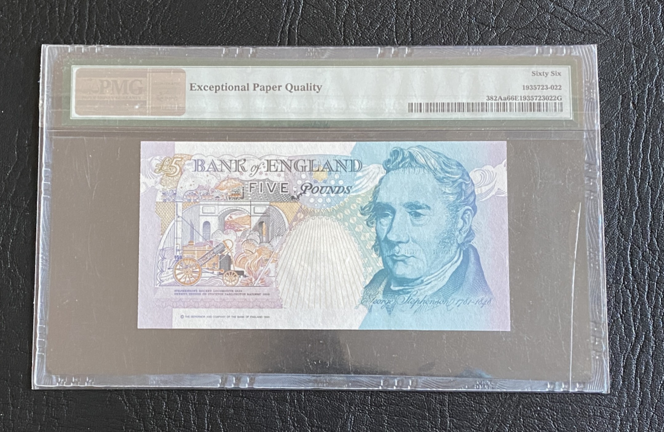 得物拍卖 Chase Auction  第2期 - -世界纸币精粹（二） 1990年英国E序列5镑，PMG66分，首发皇冠版！背面蒸汽机车发明者：乔治·斯蒂芬森。