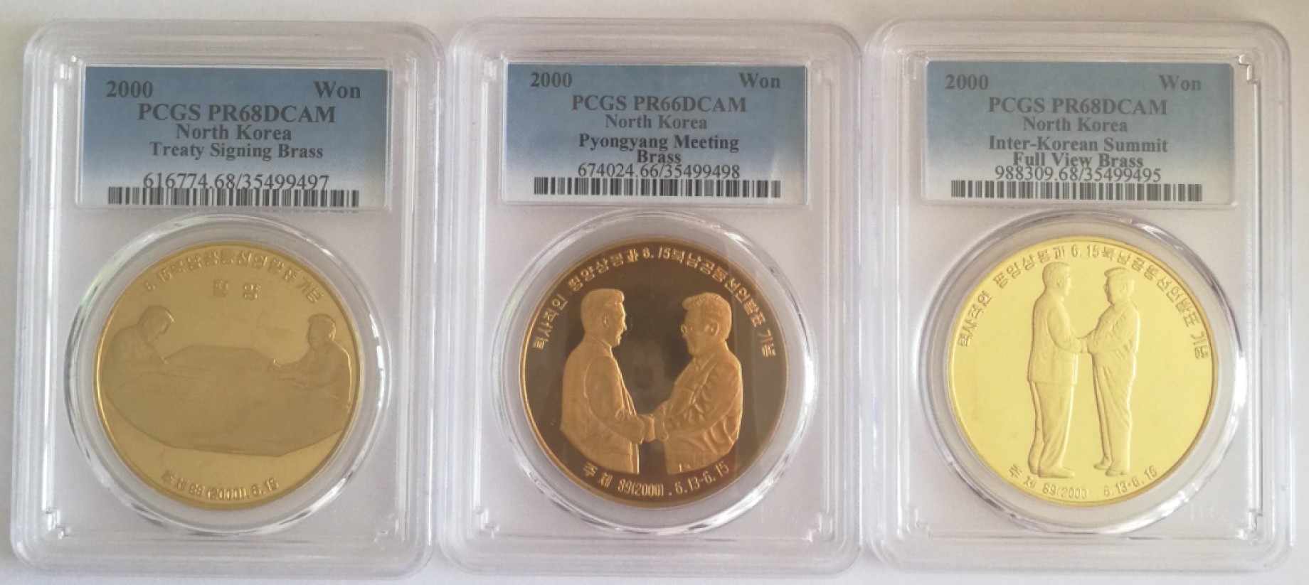 2000朝鲜1元精制铜币金正日与金大中三枚套PCGS