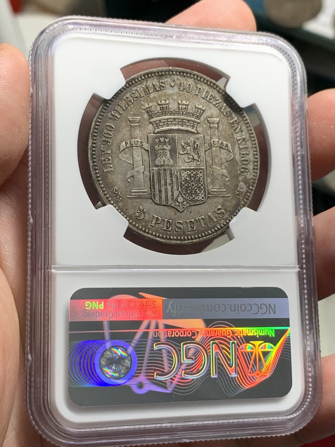 《竞宝斋》第68场-本周日，周一，周四.3场连拍（全场不限金额包邮） NGC-45 西班牙 1870年 坐人拿花 5比塞塔双柱银币 带点环彩包浆 非常难得的味道