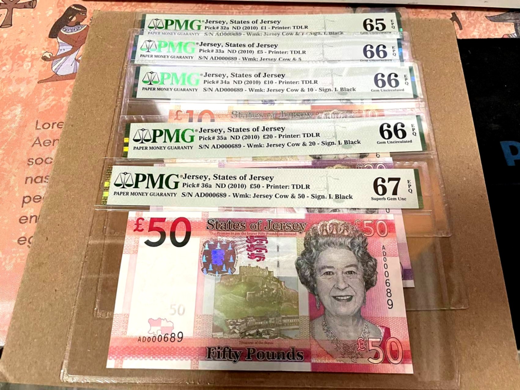 新纪元！【Blue Auction】✨世界纸币精拍第201期【精】   【一组5张 首发全同689小号】泽西 2010年5-50镑 PMG67EPQ-65EPQ（最高值67分）女王纸币 精美