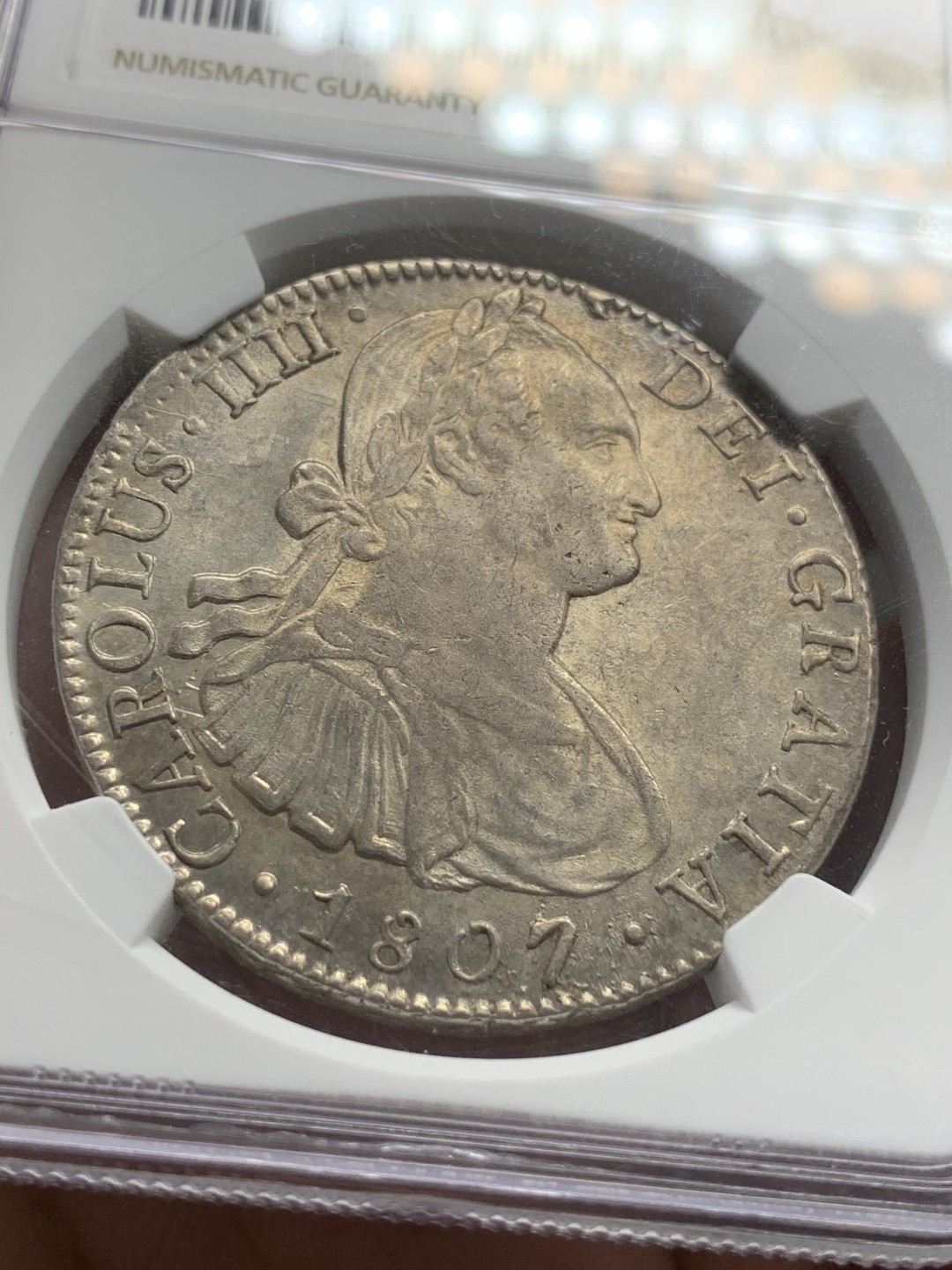 《竞宝斋》第85场-本周日，周一2场连拍（全场不限金额包邮） NGC AU58 1807年墨西哥双柱8R银币 自然包浆 底光透现 背面感光极佳 正面人像左侧有透打 打制深极难得