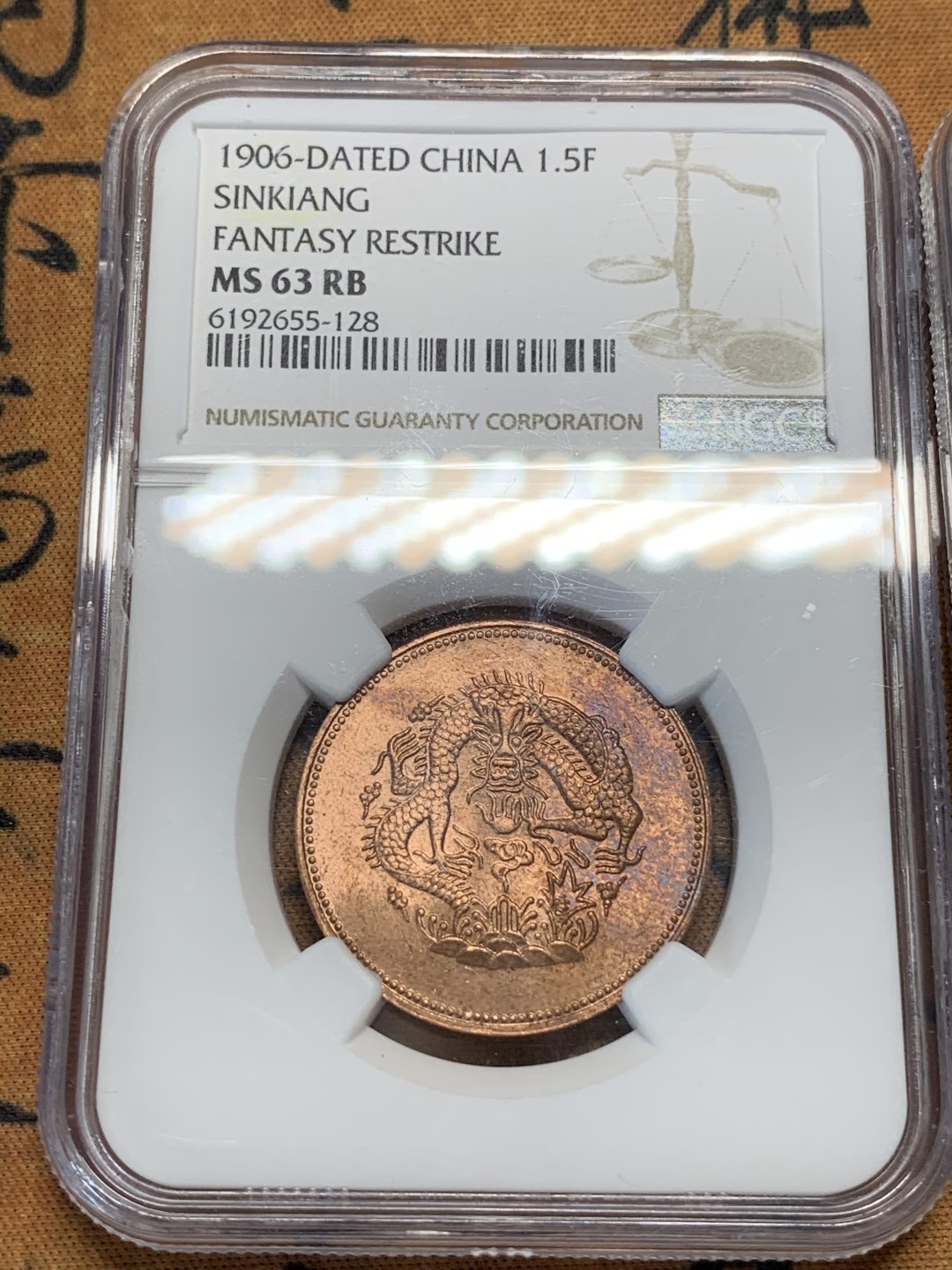 《竞宝斋》第91场-本周日，周一2场连拍（全场不限金额包邮） NGC-63RB 新疆1906年1分5厘、1910年10分红钱后铸铜币两枚 带车轮转光