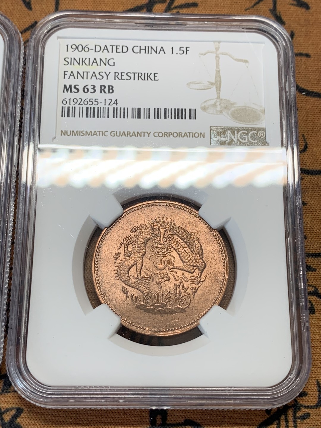 《竞宝斋》第95场-本周日，周一，周四，3场连拍（全场不限金额包邮） NGC-MS63RB 新疆1906年一分五厘、1910年当红钱十文后铸铜元两枚一对，后铸款 车轮转光