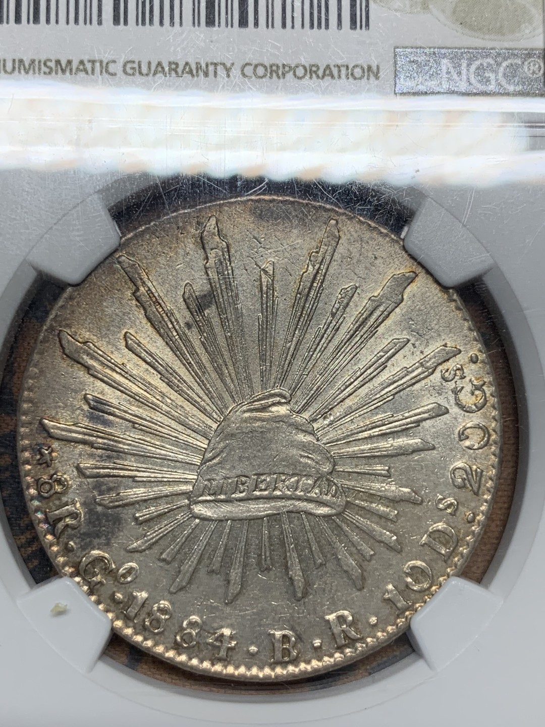 《竞宝斋》第96场-本周日，周一，周四，3场连拍（全场不限金额包邮） NGC AU58墨西哥1884年花边鹰洋8R银币 边缘环彩