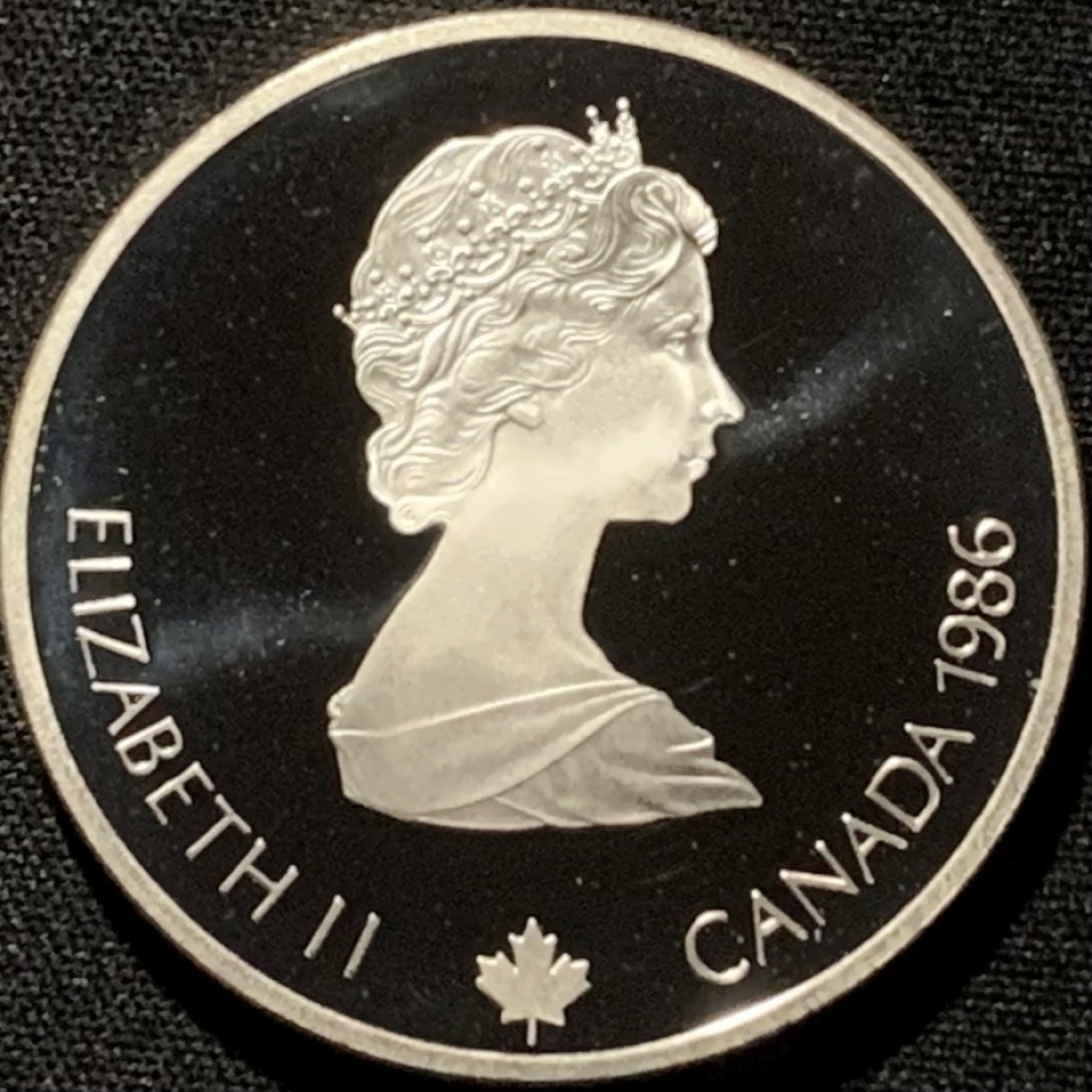 紫瑗钱币——第216期拍卖 加拿大 1986年 卡尔加里冬奥会 卧射 20元 34.1克 0.925银 精制