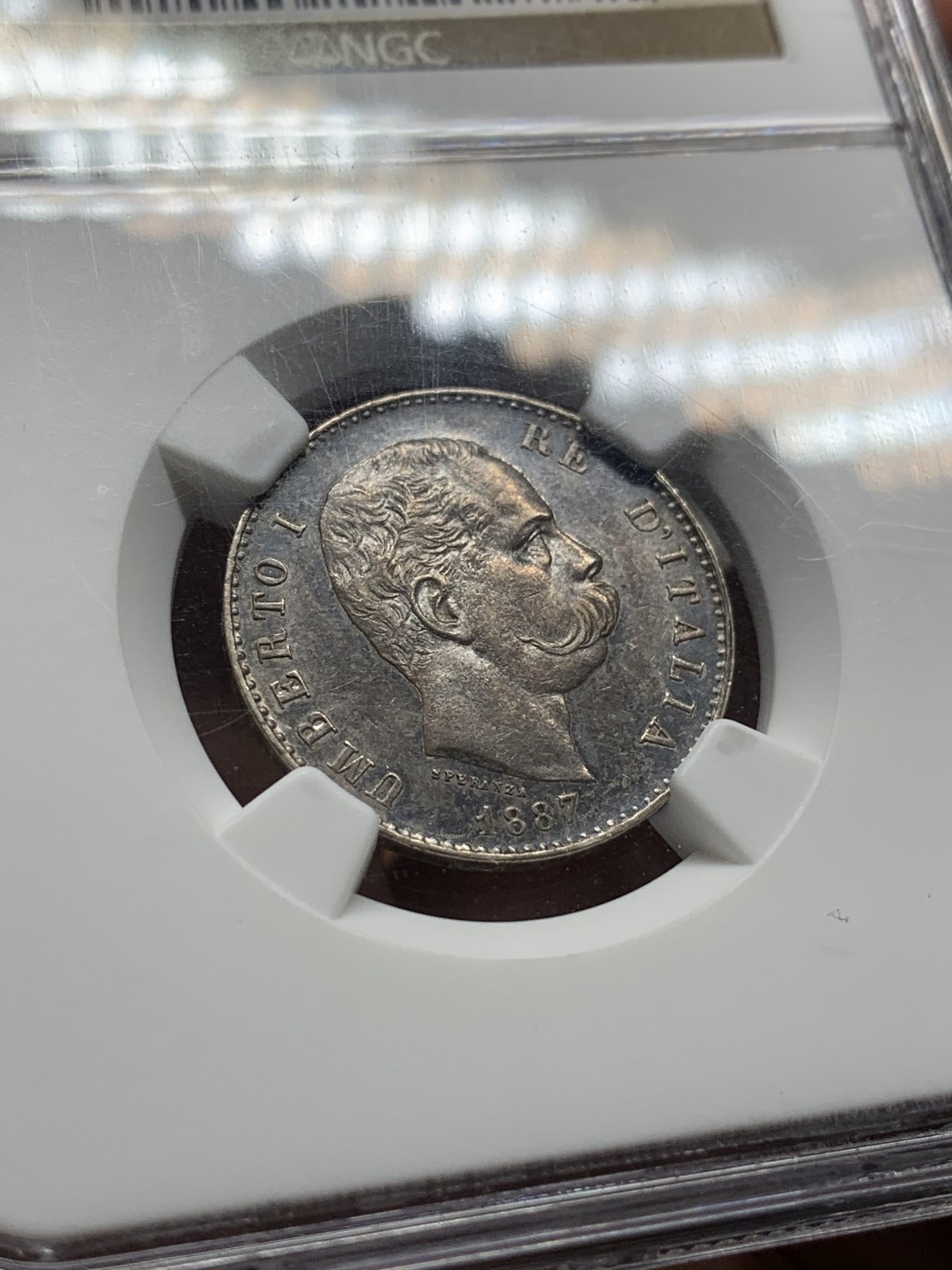 《竞宝斋》第106场-周日，周一 2场连拍（全场包邮） NGC MS62 意大利 1887年 翁贝托1里拉 银币 双面深五彩包浆 状态难得