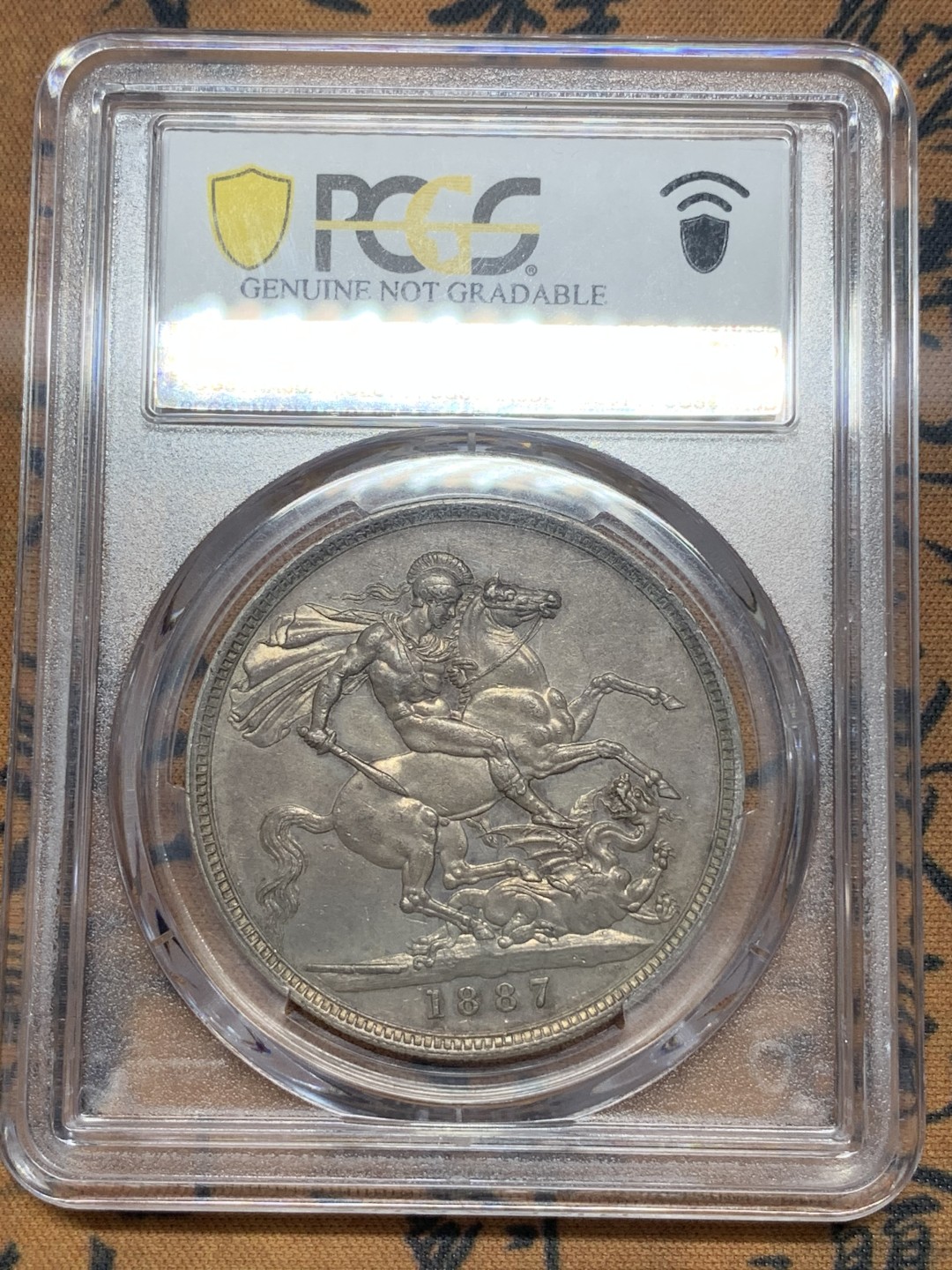 《竞宝斋》第111场-周日，周一 ，2场连拍（全场包邮） PCGS AU好品 英国1887年维多利亚高冠马剑一克朗银币背面非常好正面脸上一个小划痕 适为包浆磨损