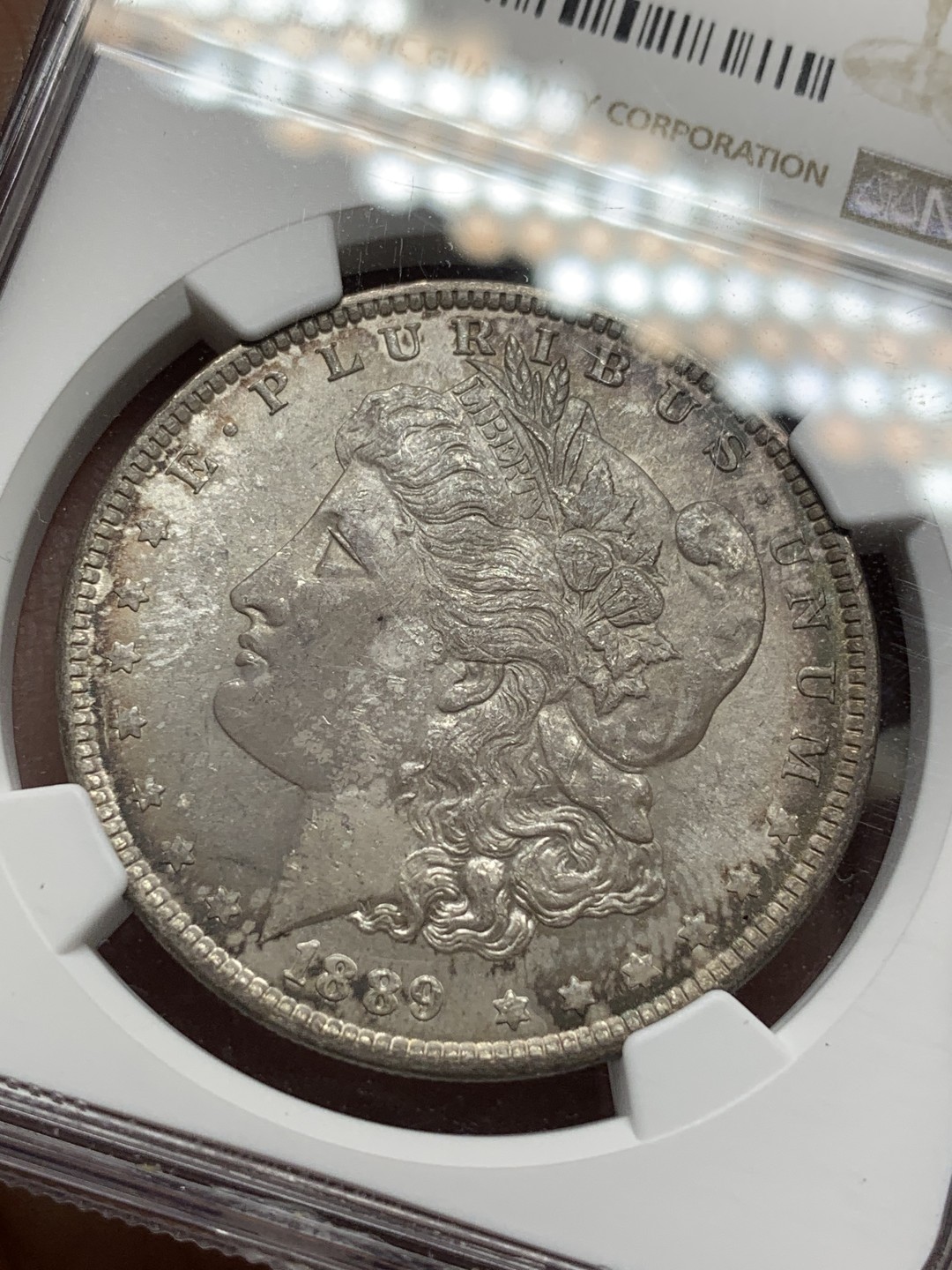 《竞宝斋》第112场-周日，周一 ，2场连拍（全场包邮） NGC-MS64 1889摩根银币 绒布盒保存产生的环彩包浆 状态完胜64白币