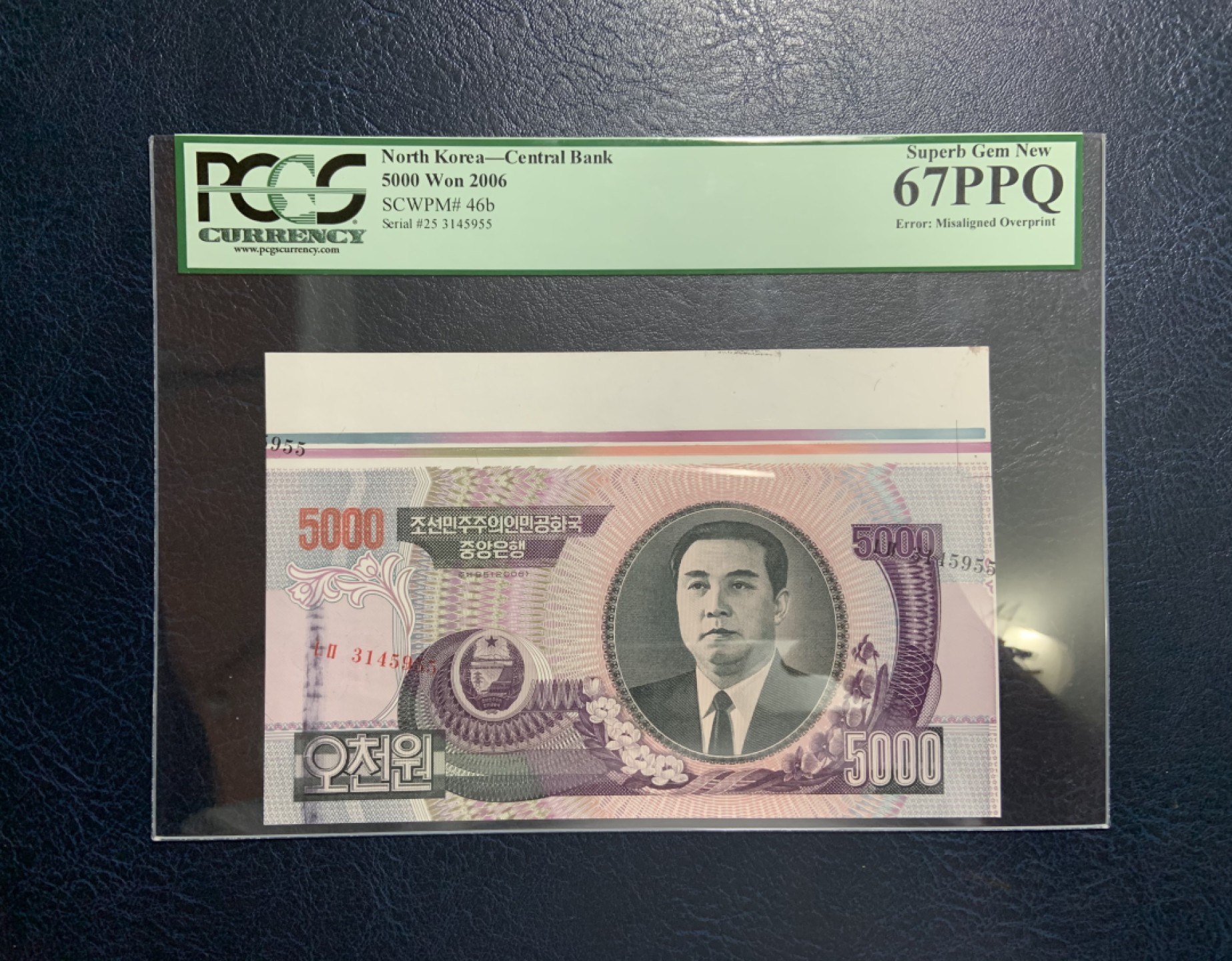 收藏联盟Quantum Auction 第207期拍卖 朝鲜2006年5000元 PCGS67 错版币(卡纸导致号码偏移，黑色划痕为质检笔) 带白边印钞纸整张纸币极少见