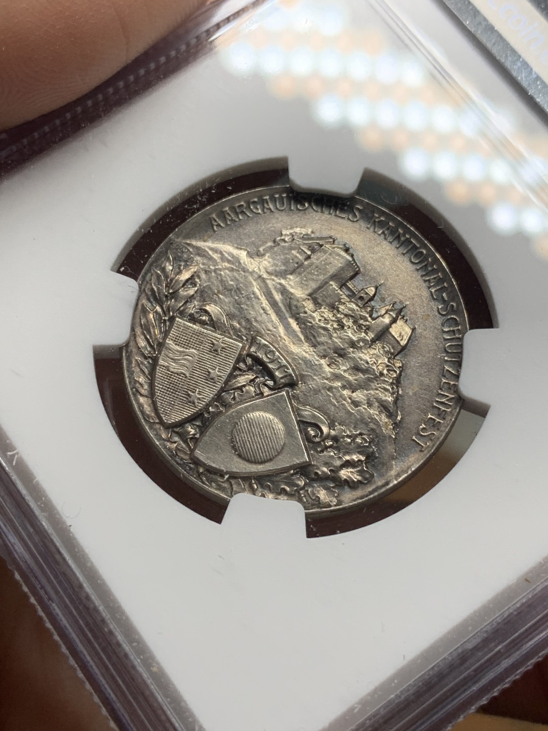 《竞宝斋》第115场-周日，周一 ，2场连拍（全场包邮） NGC UNC 1911年瑞士阿尔高射击节银章，景观设计精美，少见品种