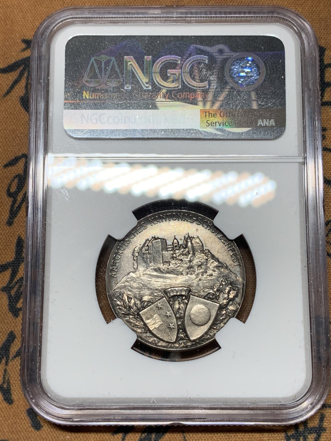 《竞宝斋》第115场-周日，周一 ，2场连拍（全场包邮） NGC UNC 1911年瑞士阿尔高射击节银章，景观设计精美，少见品种