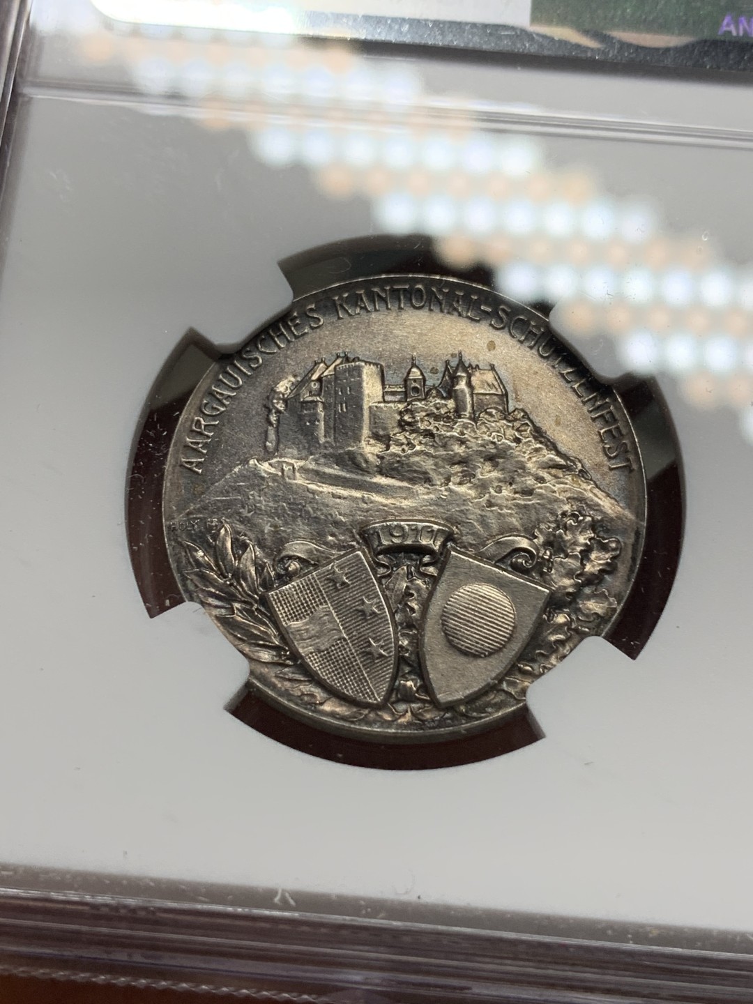 《竞宝斋》第115场-周日，周一 ，2场连拍（全场包邮） NGC UNC 1911年瑞士阿尔高射击节银章，景观设计精美，少见品种