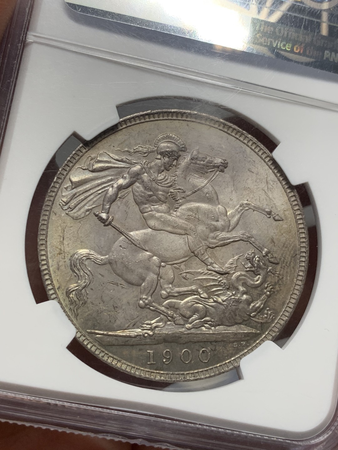 《竞宝斋》第135场-周日，周一连拍 (全场包邮) NGC MS62 英国 1900年 批纱马剑克朗 较少年份 该枚彩中彩 正面金彩 三点-八点方向 孔雀绿月牙彩 背面马剑包浆舒服 肌肉线条勾勒清晰