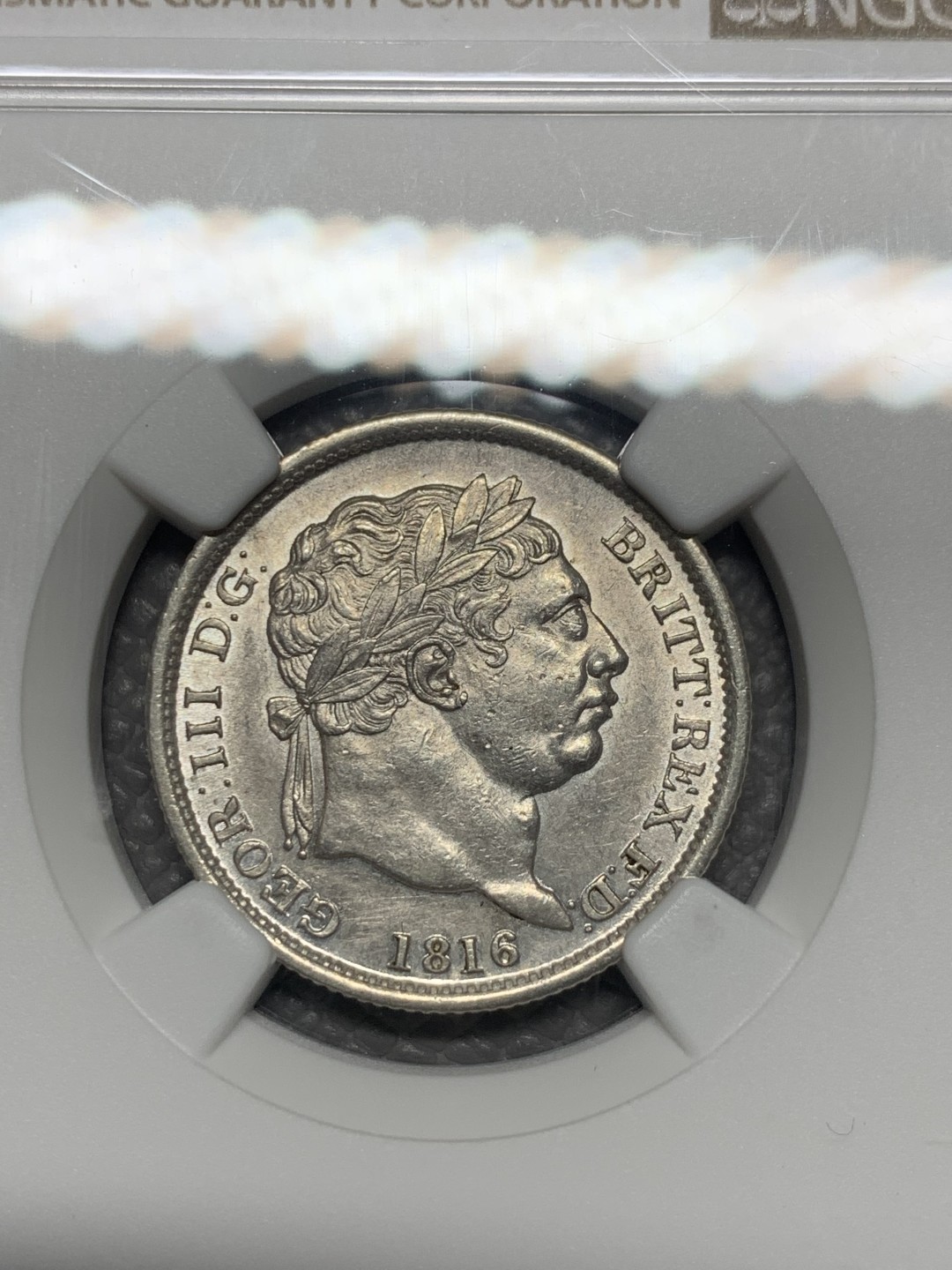 《竞宝斋》第135场-周日，周一连拍 (全场包邮) NGC MS61 英国 1816年 乔三牛头 1先令 银币 上涨品种