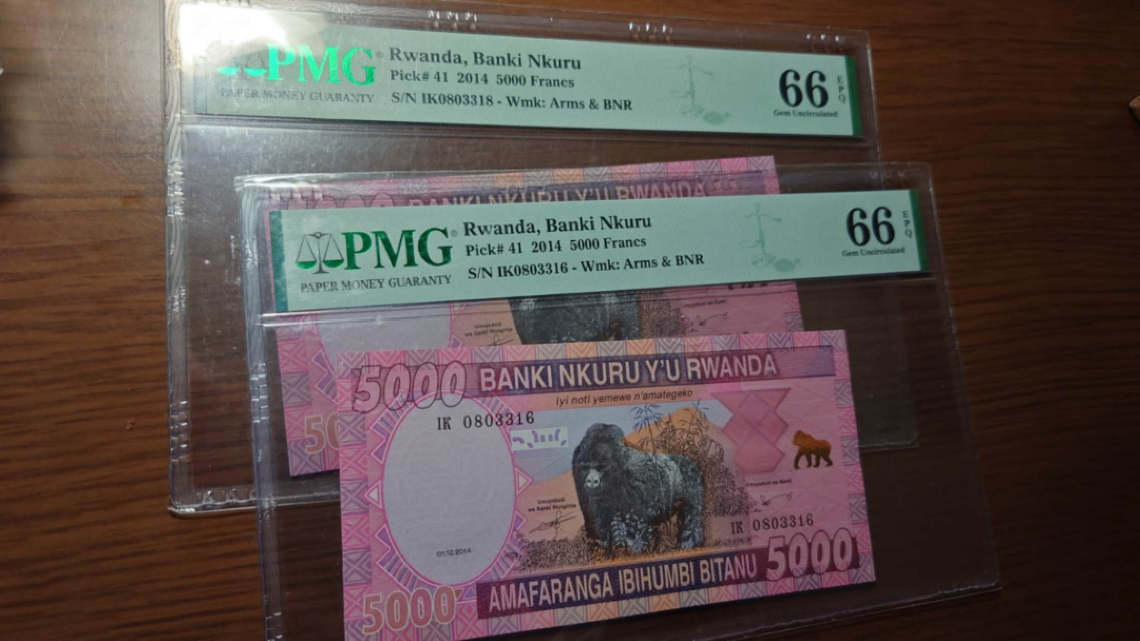 【世界钱币】精选微拍第56期暨2023年第三期  评级币专场 2014年卢旺达5000先令 PMG66E如图两张一起拍