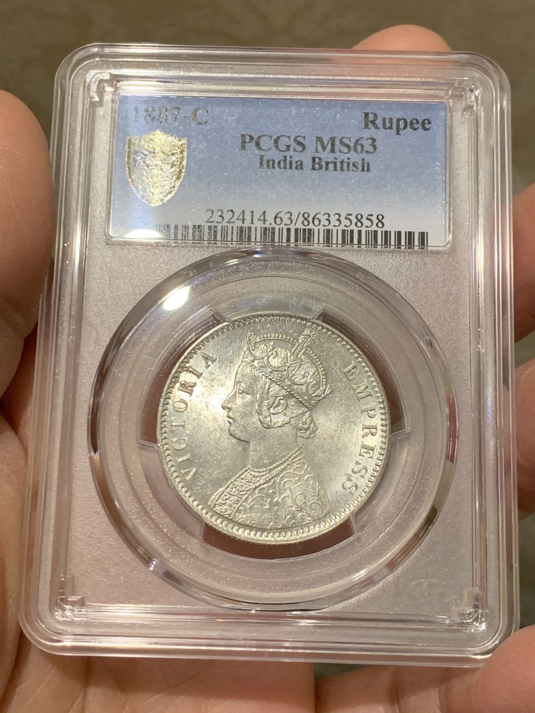 《竞宝斋》第146场-周日，周一 2场 (全场包邮) PCGS-MS63 英属印度1887 维多利亚（小维）卢比 卷拆原光，品相完美