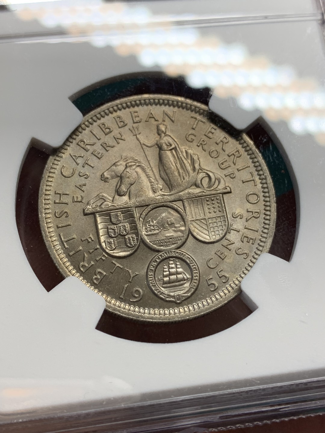 《竞宝斋》第147场-周日，周一 2场 (全场包邮) NGC MS64英属东加勒比1955年50分背面女王手握波塞冬的三叉戟并控制着马头鱼尾的神兽是希腊神话中的Hippocampu是，象征着掌握东加勒比海的海洋霸权