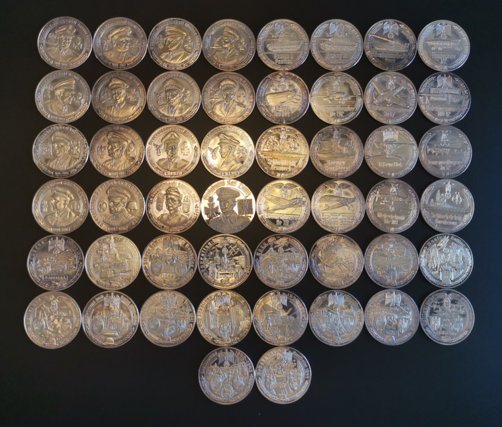 万国钱币拍卖第005期 第二次世界大战纪念章，1977年德国出品，一套共50枚，999高银，在主要战役、高级将领、新式武器等方面介绍了二战期间的战争历程，背面统一设计（见末图），可以视为钱币版的二战纪实录。统一直径50MM，重量35G，精制喷砂光边工艺制作，总重量达到1750KG。