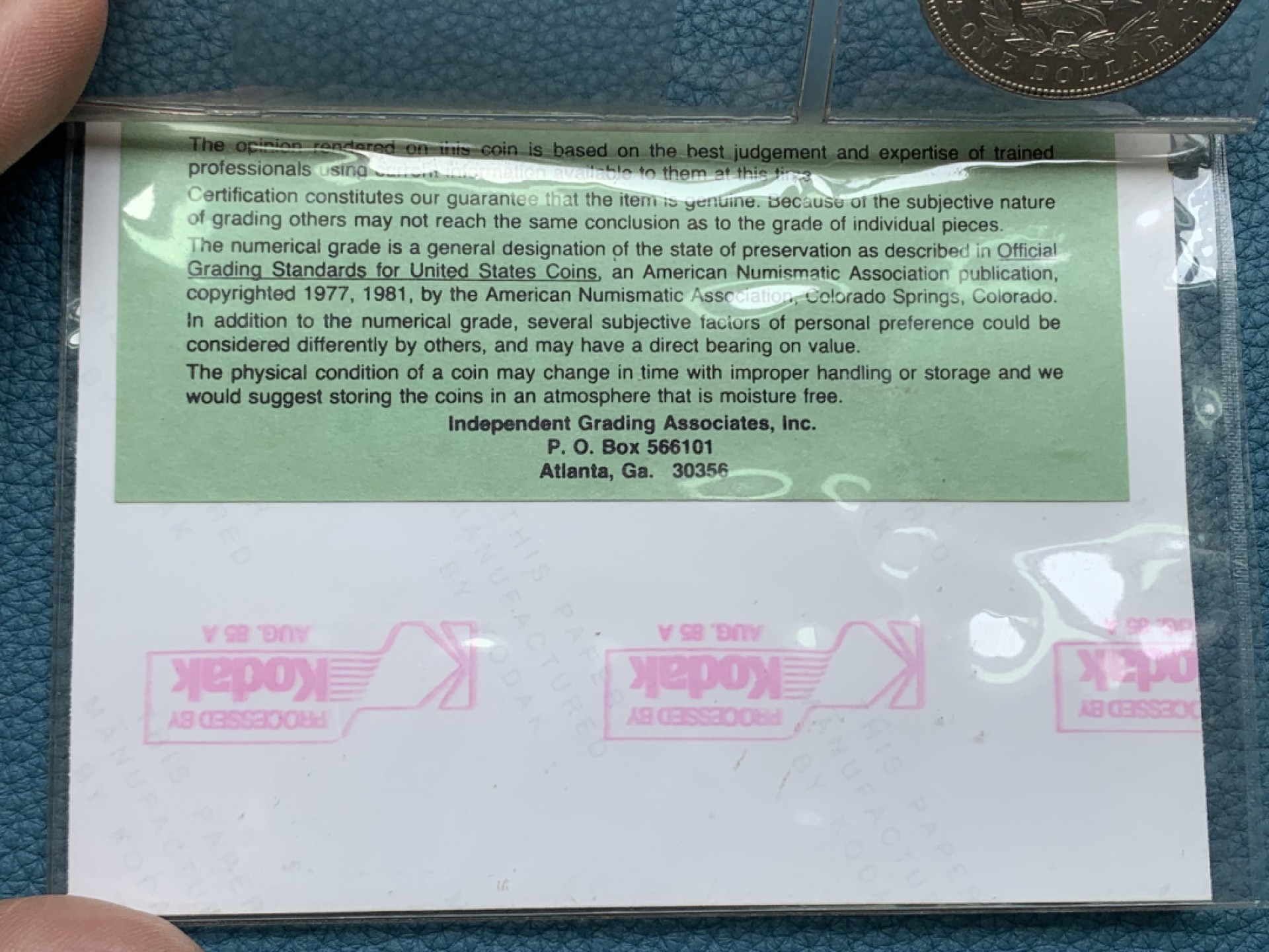 《竞宝斋》三少爷老婆本专场-第156场 (全场包邮) 早期ICG，80年代评级 MS64/65 美国1885年摩根大银币。ICG早期评级的产物，1985年8月27日评级。当时的评级规则是正反面分别评级，正面MS64，反面MS65，附柯达相纸印的币原始照片一张。