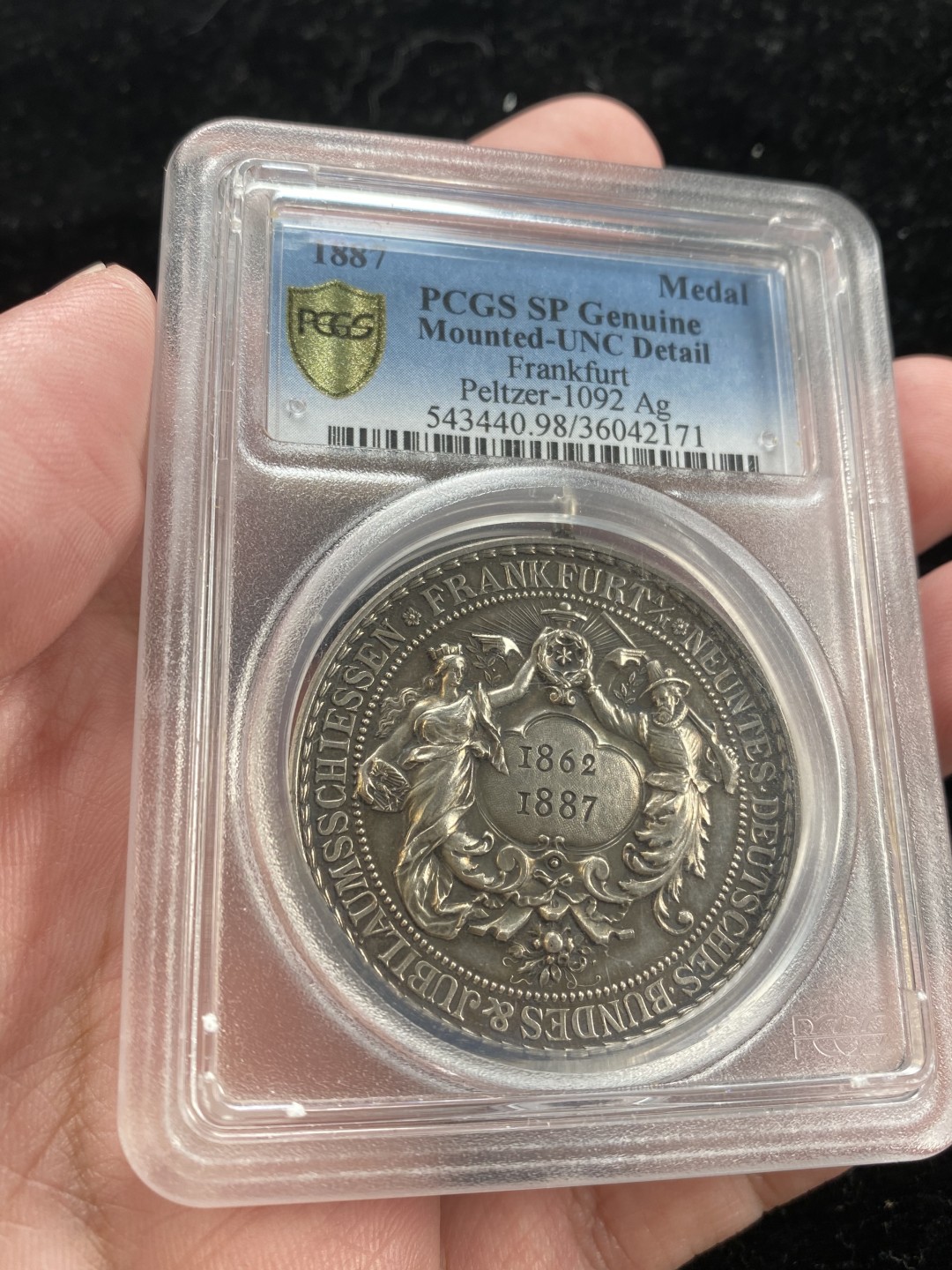 万国钱币拍卖第007期（慕尼黑第二夜） PCGS-UNCD 法兰克福1887年射击节银章带吊环，经典品种，黑色包浆更添韵味，PC加厚盒。