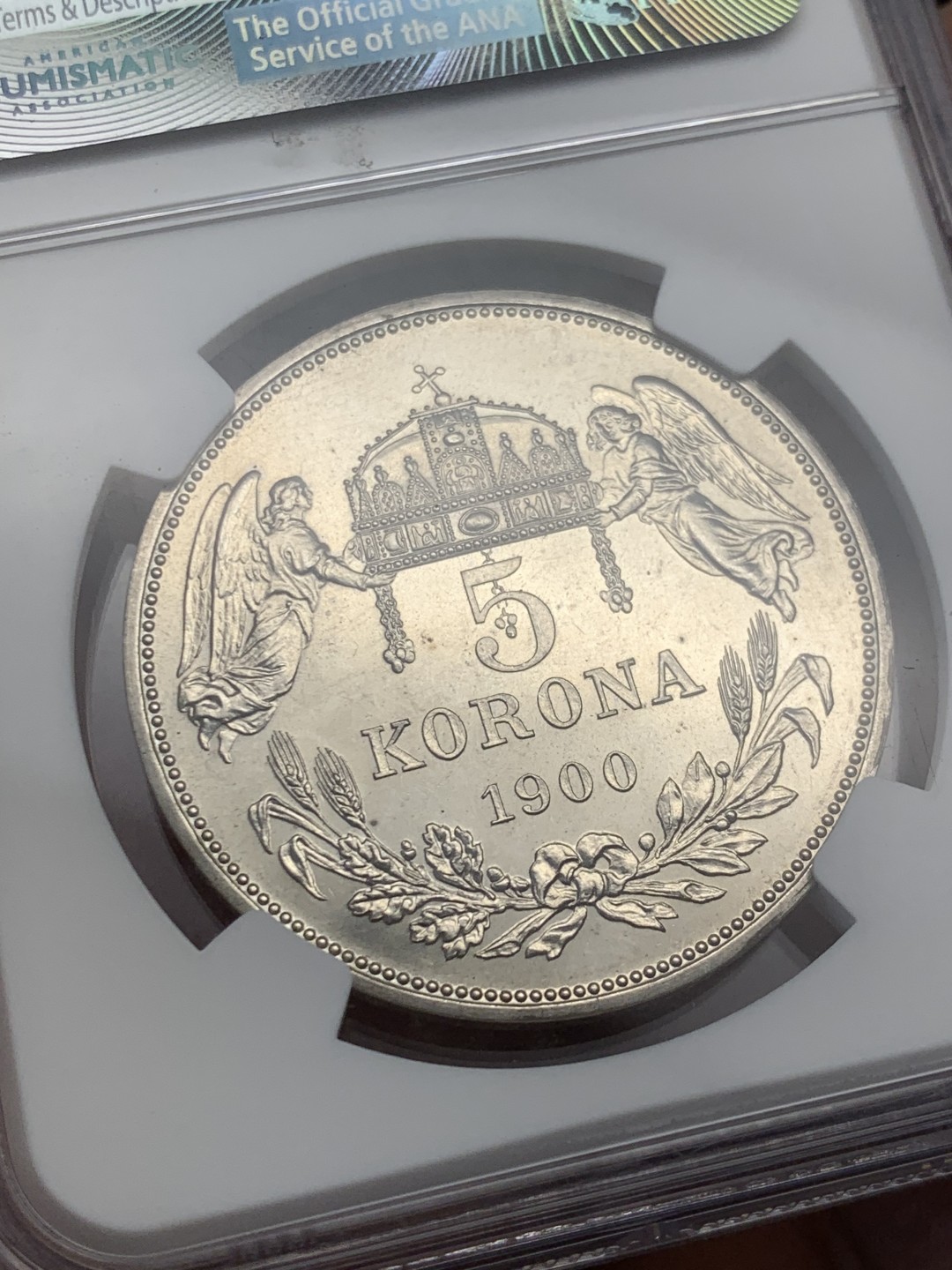 欢迎参加《竞宝斋》五一特拍-第161场-周日，周一 2场 NGC-PF64 匈牙利 1900年 天使5克朗大银币 早期后铸 皇帝名字FERENCZ前饰有一朵小玫瑰 精制币罕见 外拍暴涨品种