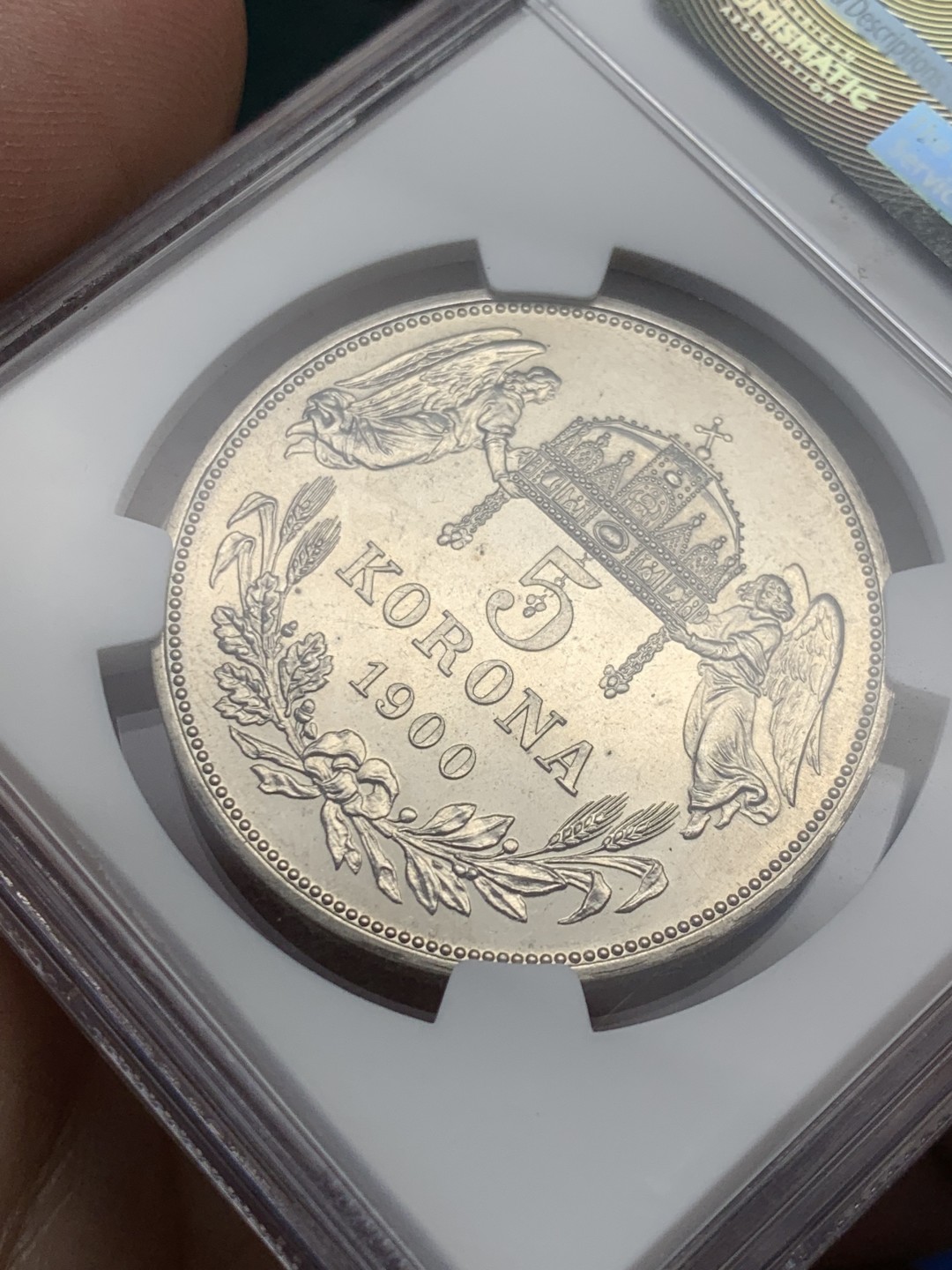 欢迎参加《竞宝斋》五一特拍-第161场-周日，周一 2场 NGC-PF64 匈牙利 1900年 天使5克朗大银币 早期后铸 皇帝名字FERENCZ前饰有一朵小玫瑰 精制币罕见 外拍暴涨品种